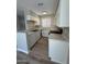 Updated kitchen with white cabinets, granite countertops, and modern flooring; dishwasher coming soon at 97 N Cooper Rd # 97, Chandler, AZ 85225