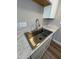 Stainless steel kitchen sink with modern faucet and elegant marble-look countertop and white cabinets at 97 N Cooper Rd # 97, Chandler, AZ 85225