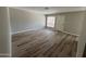 Bright living room featuring stylish wood-look floors and door to the outside patio space at 97 N Cooper Rd # 97, Chandler, AZ 85225