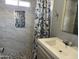 Bathroom with tiled shower, decorative shower curtain and modern fixtures at 9913 E Main St # 40, Mesa, AZ 85207