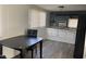 Eat-in kitchen area with black dining table and chairs with modern laminate flooring at 9913 E Main St # 40, Mesa, AZ 85207