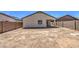 Spacious backyard with dirt landscaping, block wall fencing, and a view of a covered patio at 10430 E Sunflower Ln, Florence, AZ 85132