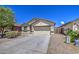 Charming single-story home with desert landscaping, a two-car garage and neutral exterior paint at 10430 E Sunflower Ln, Florence, AZ 85132