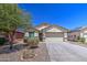Charming single-story home with desert landscaping, a two-car garage and neutral exterior paint at 10430 E Sunflower Ln, Florence, AZ 85132