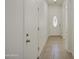 Entryway hallway featuring tiled flooring, white walls, and a decorative glass front door at 10430 E Sunflower Ln, Florence, AZ 85132