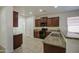 The kitchen features granite counters, dark wood cabinets, black appliances, and ceramic tile floors at 10430 E Sunflower Ln, Florence, AZ 85132