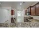 The kitchen is updated with granite counters, dark wood cabinetry, and modern appliances at 10430 E Sunflower Ln, Florence, AZ 85132