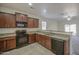 Well-equipped kitchen featuring granite counters, stainless steel appliances, and dark wood cabinetry at 10430 E Sunflower Ln, Florence, AZ 85132