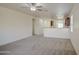 Open-concept living room showcasing new carpet, neutral paint, and seamlessly connecting to the kitchen at 10430 E Sunflower Ln, Florence, AZ 85132