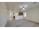 Open-concept living room showcasing new carpet, neutral paint, and seamlessly connecting to the kitchen at 10430 E Sunflower Ln, Florence, AZ 85132