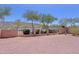 The backyard has a block wall, black fence and desert landscaping at 1125 E Milada Dr, Phoenix, AZ 85042