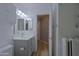 Clean bathroom with light vanity, cabinet storage and view to hallway at 1125 E Milada Dr, Phoenix, AZ 85042