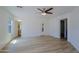 Open bedroom showcases wood-look floors, ceiling fan, multiple windows and convenient access to ensuite bathroom at 1125 E Milada Dr, Phoenix, AZ 85042