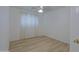 Bright bedroom featuring light wood floors, a ceiling fan, and large windows for natural light at 1125 E Milada Dr, Phoenix, AZ 85042