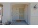 Covered front porch showcasing the home's address, updated light fixture, and secured screen door at 1125 E Milada Dr, Phoenix, AZ 85042