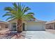 Single level home with desert landscaping, showing the garage and front door at 1125 E Milada Dr, Phoenix, AZ 85042