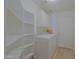 White laundry room with washer, dryer, and storage shelves at 1125 E Milada Dr, Phoenix, AZ 85042