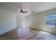 Bright living room boasts wood-look floors, modern ceiling fan, and views of the surrounding landscape at 1125 E Milada Dr, Phoenix, AZ 85042