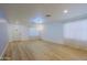 Spacious, light-filled living room featuring wood-look flooring and large windows at 1125 E Milada Dr, Phoenix, AZ 85042