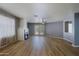 Cozy living space featuring a fireplace, wood-look flooring, and access to the backyard at 1125 E Milada Dr, Phoenix, AZ 85042