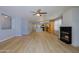 Open living space with wood-look flooring, fireplace, and an adjacent kitchen and dining area at 1125 E Milada Dr, Phoenix, AZ 85042