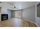 Comfortable living space showcasing a fireplace, ceiling fan, and direct access to the backyard at 1125 E Milada Dr, Phoenix, AZ 85042