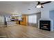 Open living space featuring modern lighting, breakfast bar, fireplace, and adjacent kitchen at 1125 E Milada Dr, Phoenix, AZ 85042
