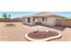 Rear exterior view, showing desert landscaping and covered patio at 11510 E Lomita Ave, Mesa, AZ 85209