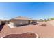 Home exterior showcasing desert landscaping and a fully fenced backyard for privacy at 11510 E Lomita Ave, Mesa, AZ 85209