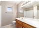 Bathroom featuring a window, and a vanity with a large mirror and a bathtub shower combo at 11510 E Lomita Ave, Mesa, AZ 85209