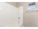 Bathtub shower combo features white subway tiles, a shower head, and a window at 11510 E Lomita Ave, Mesa, AZ 85209