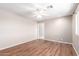 A spacious bedroom with wood floors, a ceiling fan, and a walk-in closet at 11510 E Lomita Ave, Mesa, AZ 85209