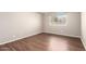 Neutral bedroom featuring wood floors, a window, and multiple electric outlets at 11510 E Lomita Ave, Mesa, AZ 85209