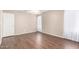 This bedroom offers a neutral palette, wood-look floors, and natural light at 11510 E Lomita Ave, Mesa, AZ 85209