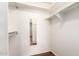 Walk-in closet featuring wood floors, a mirror, and built-in clothes rails and shelves at 11510 E Lomita Ave, Mesa, AZ 85209