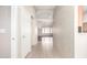A bright hallway with neutral walls, tile floors, and an arched doorway at 11510 E Lomita Ave, Mesa, AZ 85209