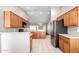 Well-equipped kitchen showcasing wood cabinetry and stainless steel refrigerator at 11510 E Lomita Ave, Mesa, AZ 85209