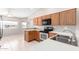 Well-lit kitchen features wood cabinets, appliances, and tile flooring at 11510 E Lomita Ave, Mesa, AZ 85209