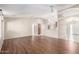 Bright, open-concept living room boasts wood flooring and ceiling fan at 11510 E Lomita Ave, Mesa, AZ 85209