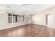 Sunlit living room featuring wood floors, neutral walls, and large windows at 11510 E Lomita Ave, Mesa, AZ 85209
