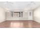 Inviting room features wood floors, back yard view, and a door at 11510 E Lomita Ave, Mesa, AZ 85209