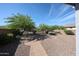Serene backyard featuring desert landscaping, decorative rock, a patio area and a sturdy wrought iron fence at 12679 W Lowden Rd, Peoria, AZ 85383