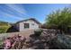 This home features a well-landscaped backyard with drought-tolerant plants and gravel at 12679 W Lowden Rd, Peoria, AZ 85383