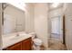 Bathroom featuring a vanity with sink, toilet, tile floors, and door to tub at 12679 W Lowden Rd, Peoria, AZ 85383