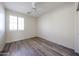 Comfortable bedroom with wood floors, ceiling fan, and bright window at 12679 W Lowden Rd, Peoria, AZ 85383