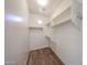 Walk-in closet with built-in shelving and wood floors at 12679 W Lowden Rd, Peoria, AZ 85383