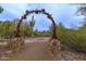 Unique desert landscape with an iron archway and desert plants at 12679 W Lowden Rd, Peoria, AZ 85383