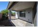 Relaxing covered patio providing shade, and views of the serene backyard with mature trees at 12679 W Lowden Rd, Peoria, AZ 85383