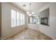 Bright dining room with shuttered windows, tile floor, and decorative chandelier at 12679 W Lowden Rd, Peoria, AZ 85383