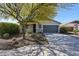 Charming single-story home with a well-maintained front yard and mature tree providing shade at 12679 W Lowden Rd, Peoria, AZ 85383